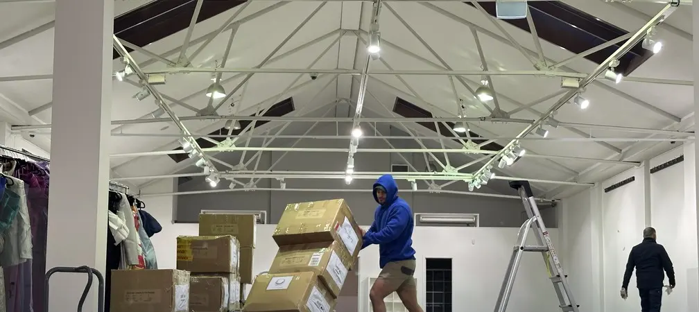 A House Removalists Melbourne crew member loading a stack of cartons onto a trolley during a Melbourne job