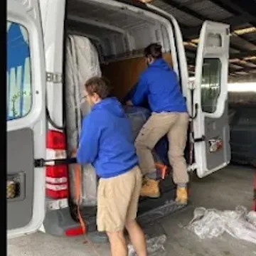 Two crew loading a van at the depot